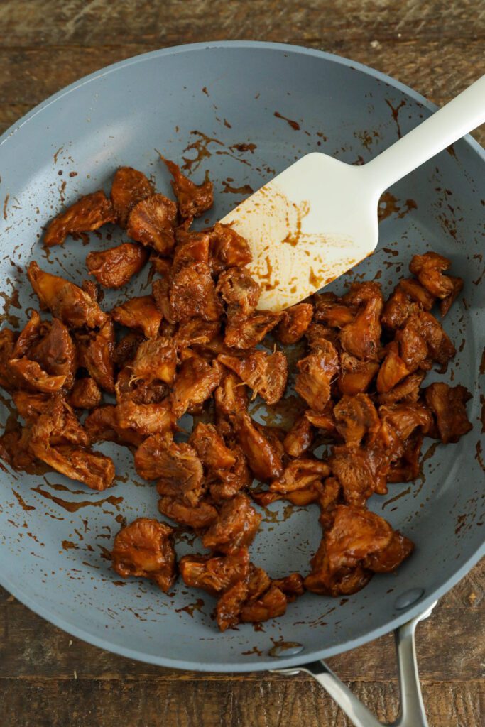 BBQ Lion's Mane Mushrooms in pan with spatula 