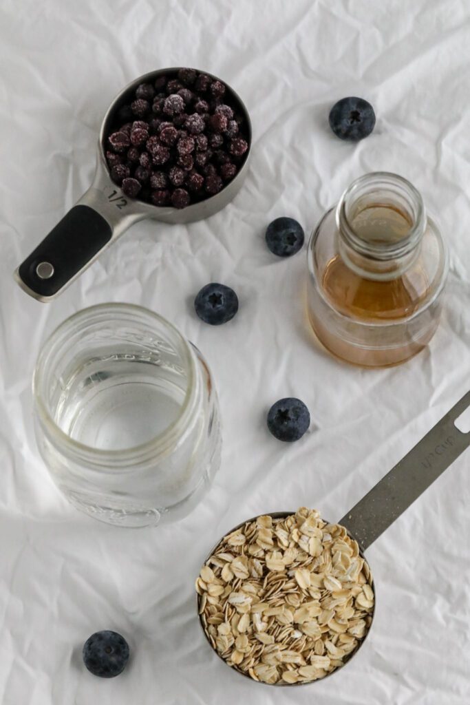ingredients for blueberry stovetop oatmeal on white towel 