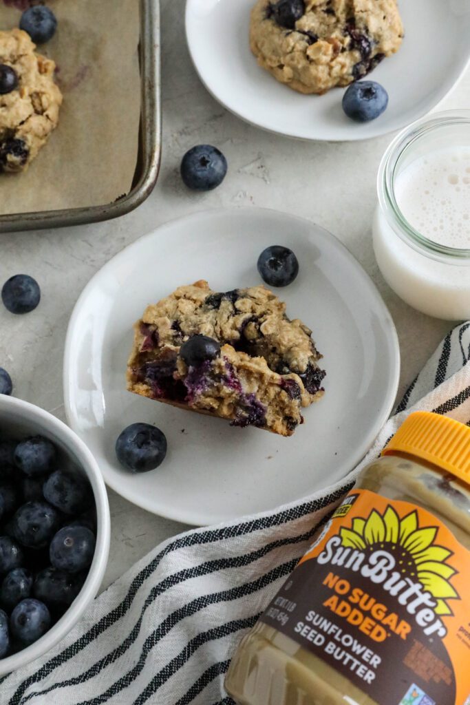 Blueberry SunButter Breakfast Cookies baked on parchment lined baking sheet and served on plates 