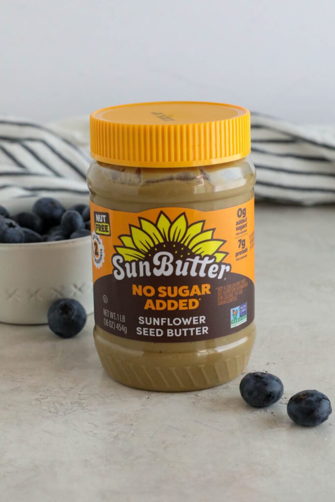 No Sugar Added SunButter on board with blueberries scattered