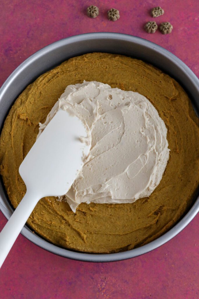 dog cake frosted with spatula 