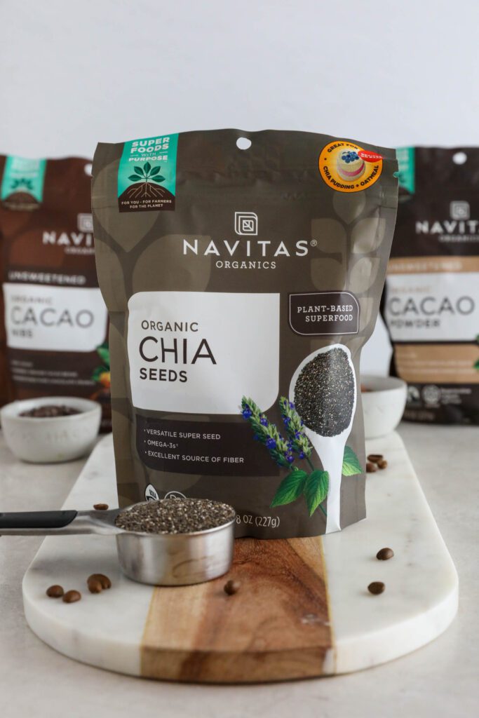 Navitas Organics Chia Seeds, Cacao Powder, and Cacao Nibs on marble board
