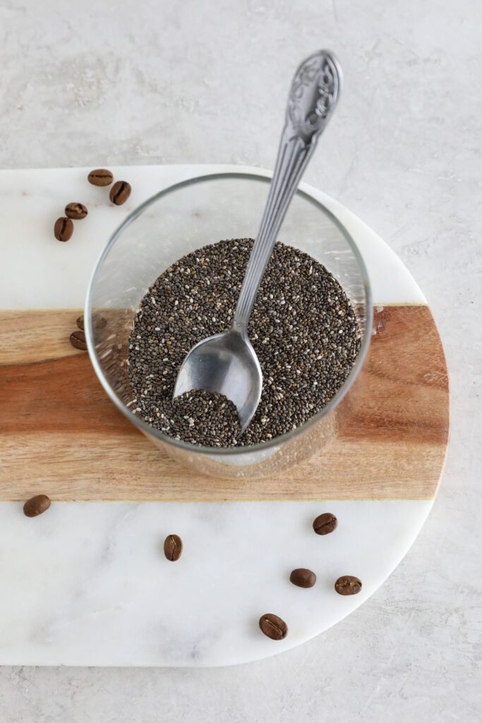 chia seeds in jar on marble board with spoon