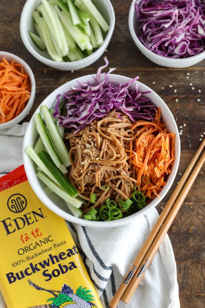 Vegan Bibim Guksu (Korean Spicy Cold Noodles) served in bowl with chopsticks