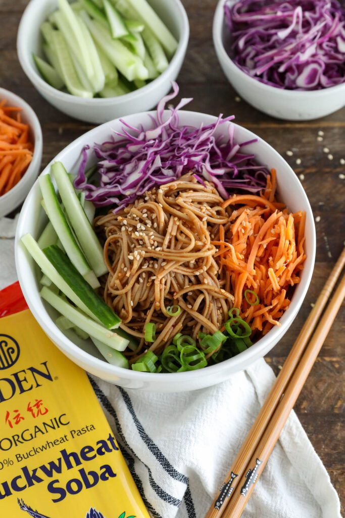 Vegan Bibim Guksu (Korean Spicy Cold Noodles) served in bowl with chopsticks