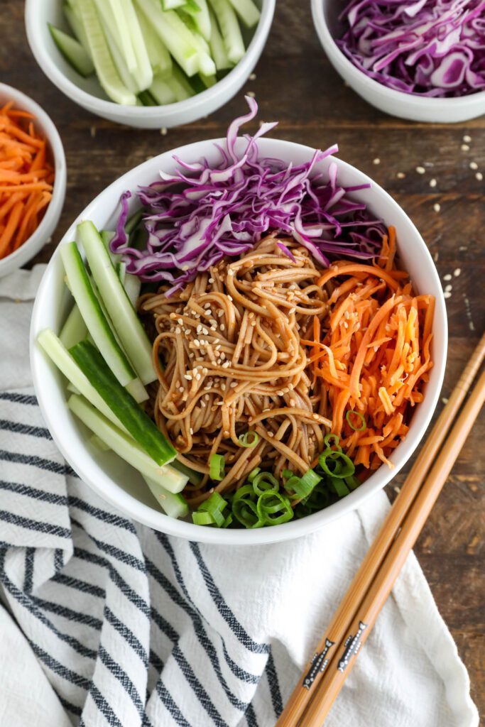 Vegan Bibim Guksu (Korean Spicy Cold Noodles) served in bowl with chopsticks