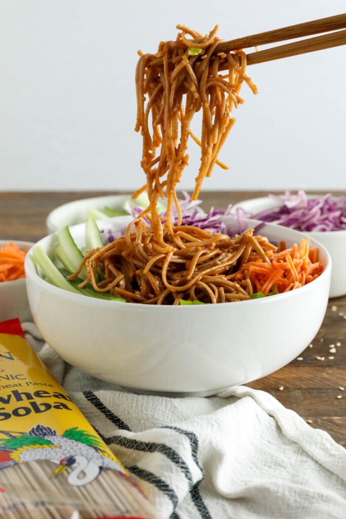 Vegan Bibim Guksu (Korean Spicy Cold Noodles) served in bowl with chopsticks