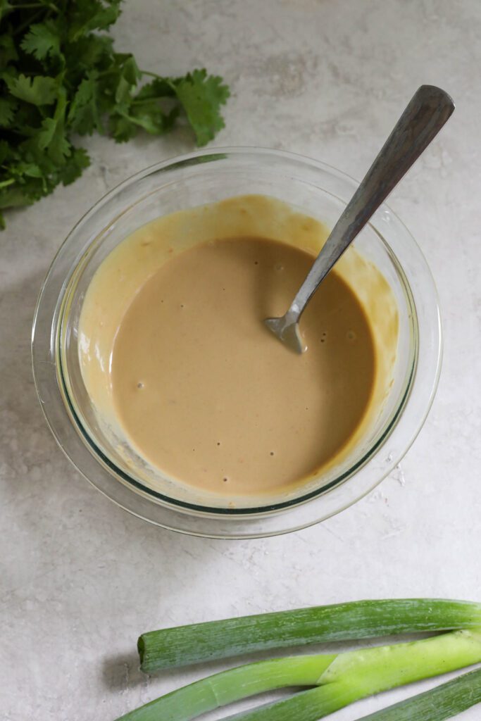 SunButter sauce in bowl with fork with cilantro on the side