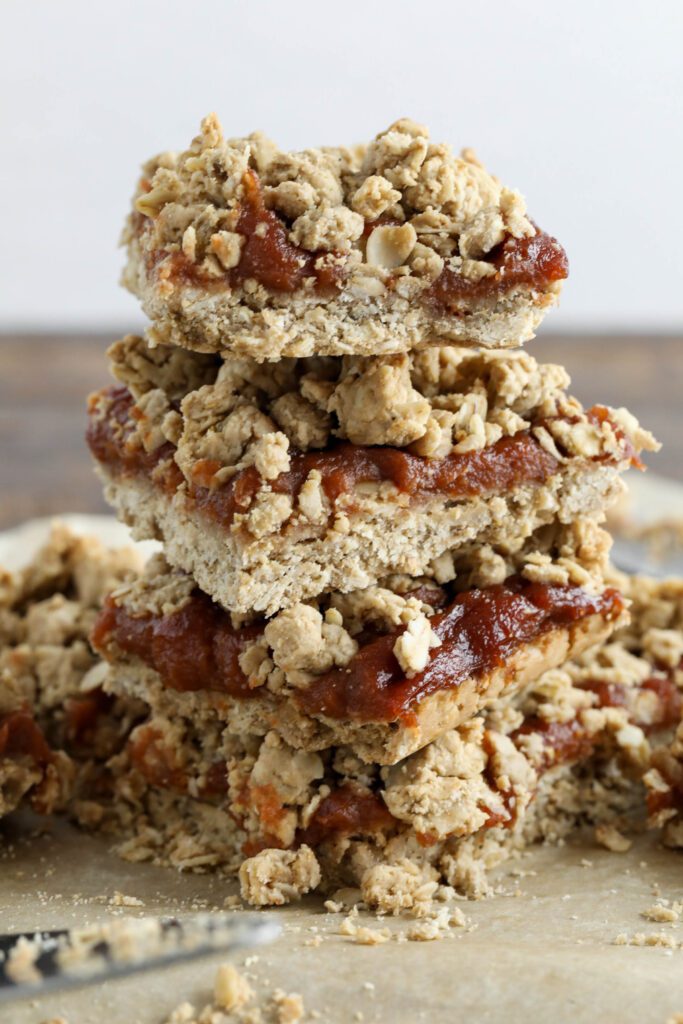 Apple Butter Crumble Bars stacked on parchment paper 