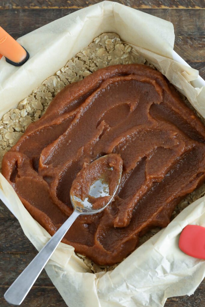 Apple Cherry butter spread on crust in parchment lined baking sheet