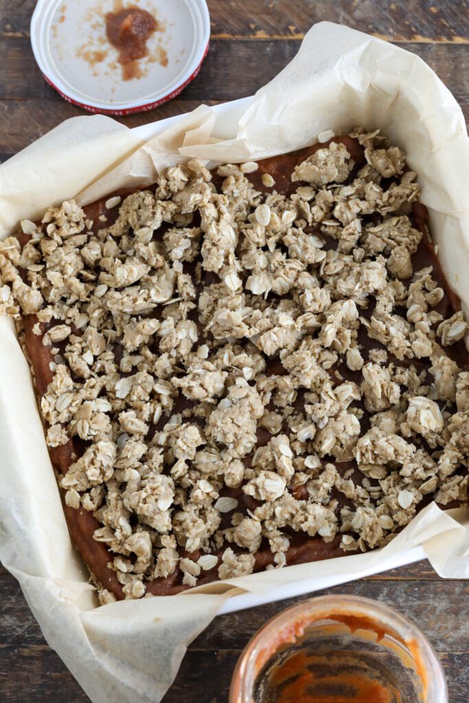 Apple Butter Crumble Bars in parchment lined baking dish