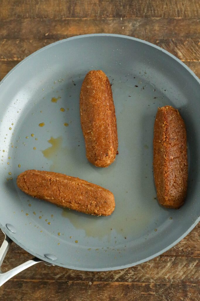 vegan bratwurst in cooked in pan 
