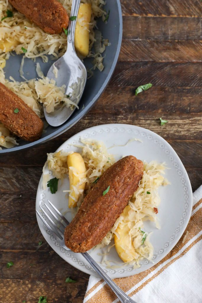 Vegan Bratwurst with Sauerkraut on plate with fork