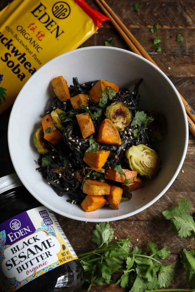 Black Sesame Noodle Bowl served in bowl topped with cilantro and sesame seeds