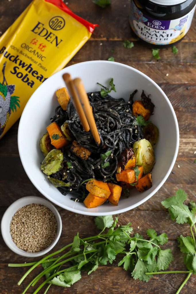 Black Sesame Noodle Bowl served in bowl topped with cilantro and sesame seeds