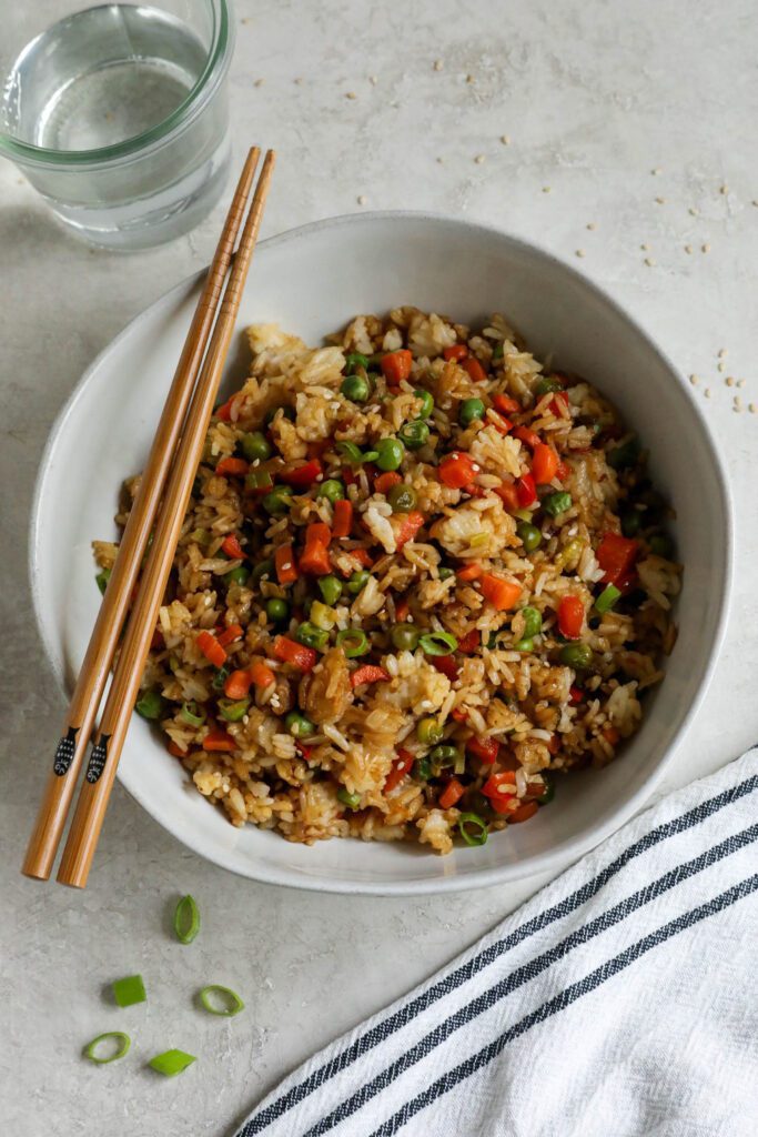 Single Serving Fried Rice in a bowl with chopsticks topped with green onions and white sesame seeds