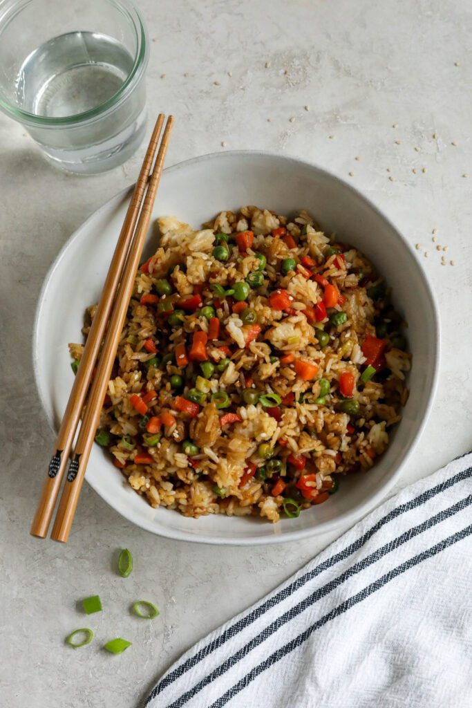 Single Serving Fried Rice in a bowl with chopsticks topped with green onions and white sesame seeds