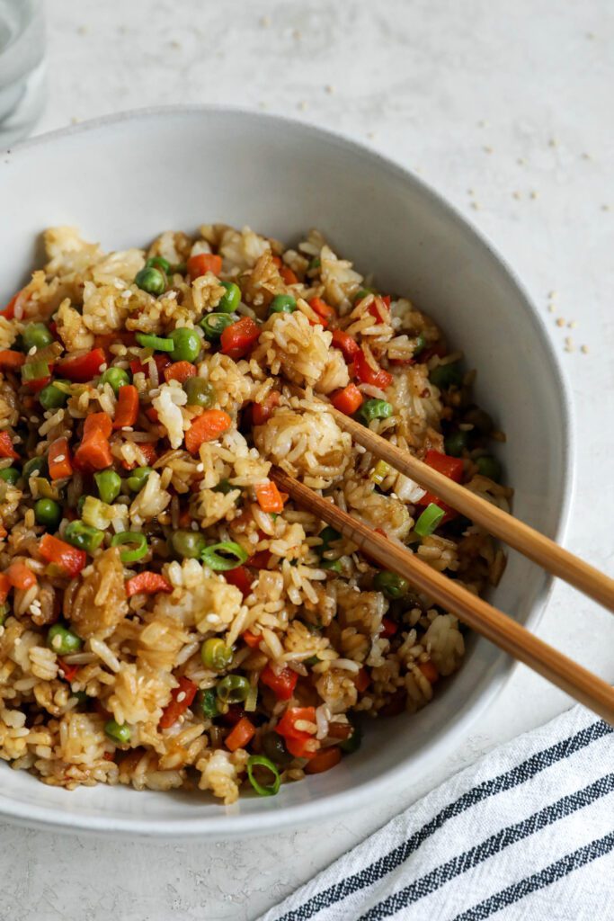 Single Serving Fried Rice in a bowl with chopsticks topped with green onions and white sesame seeds