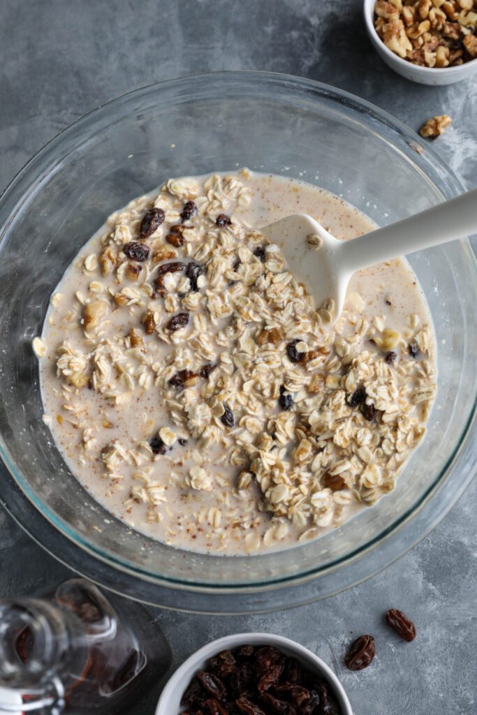 Cinnamon Raisin Cookie Baked Oatmeal batter mixed in bowl with spatula 