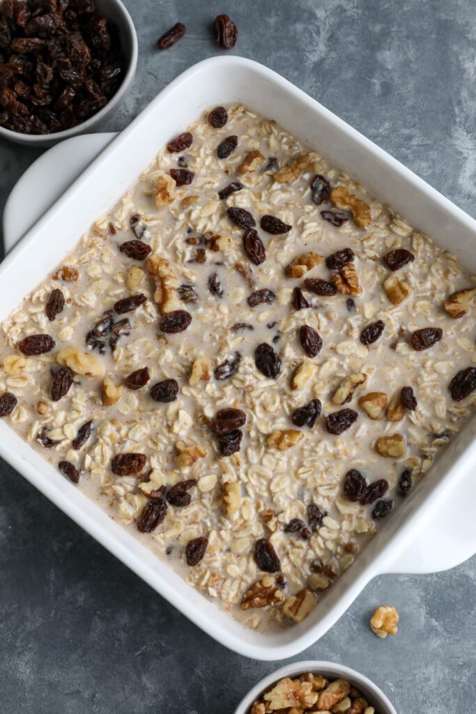 Cinnamon Raisin Cookie Baked Oatmeal added to square baking dish 