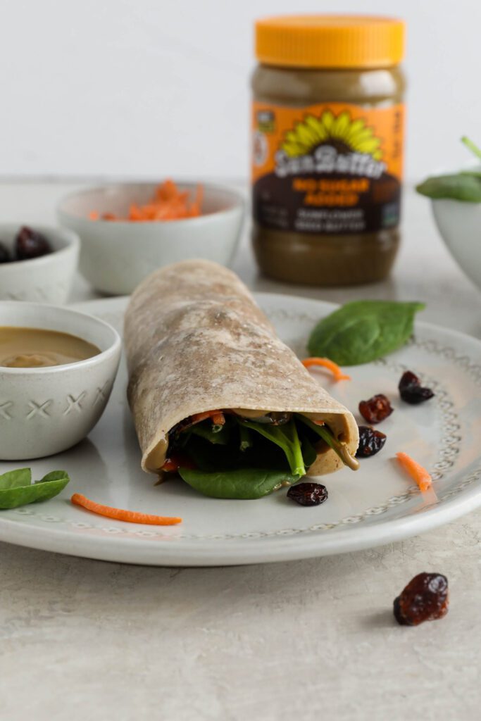 Sweet & Spicy SunButter Spinach Wrap halved and stacked on plate