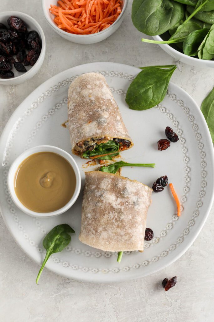 Sweet & Spicy SunButter Spinach Wrap halved and stacked on plate