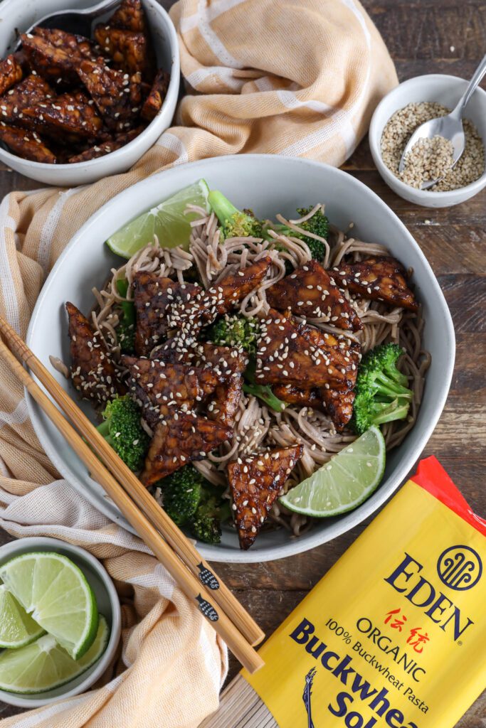 Soba Noodles with Maple Miso Glazed Tempeh served in bowl with chopsticks an sesame seeds