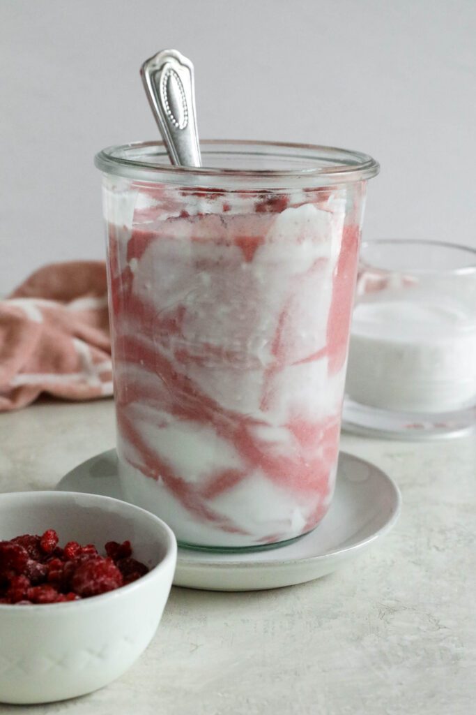 Pink Coconut Cloud Smoothie served in glass with spoon