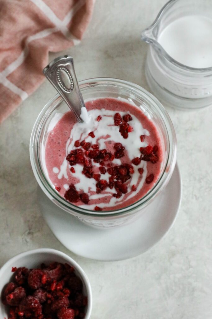 Pink Coconut Cloud Smoothie served in glass with spoon
