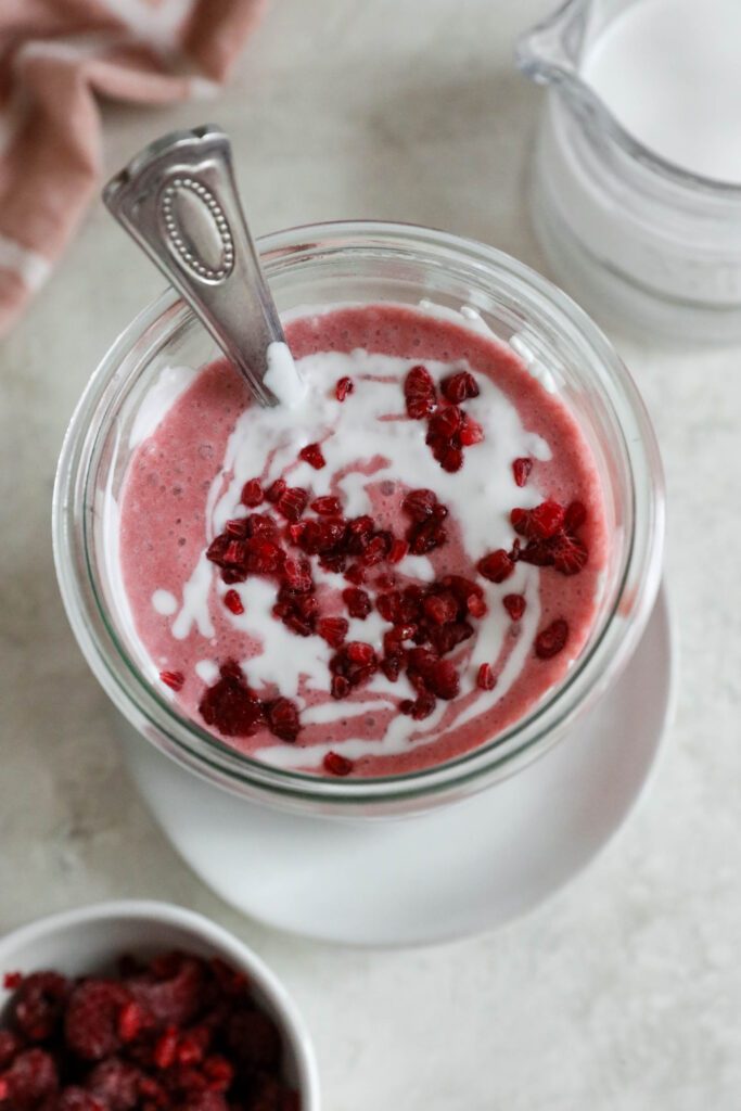 Pink Coconut Cloud Smoothie served in glass with spoon