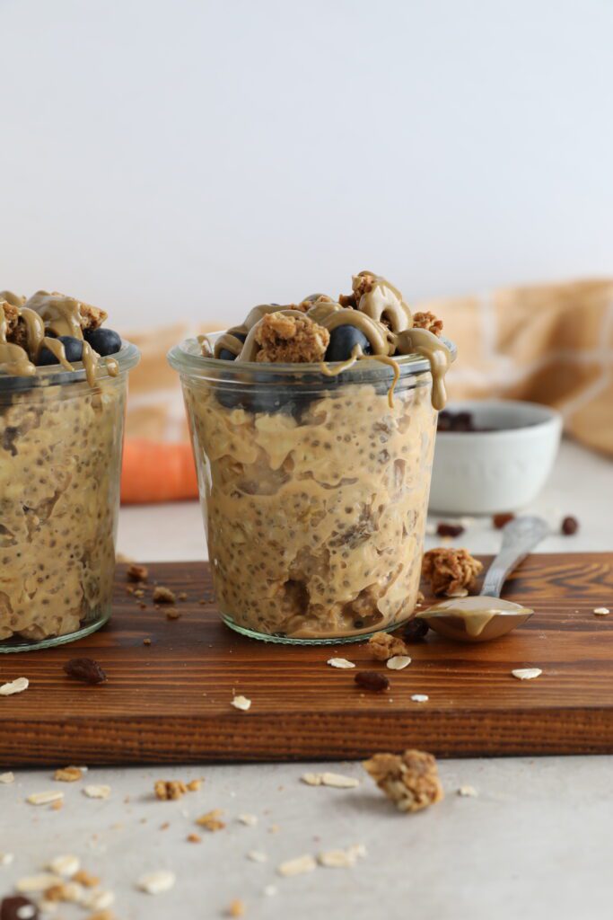 Carrot Cake SunButter Overnight Oats served in mason jars on wooden board