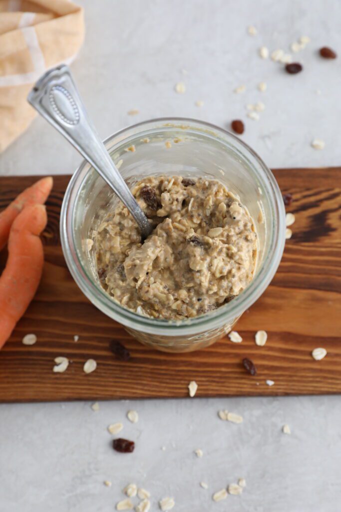 Carrot Cake SunButter Overnight Oats served in mason jars on wooden board