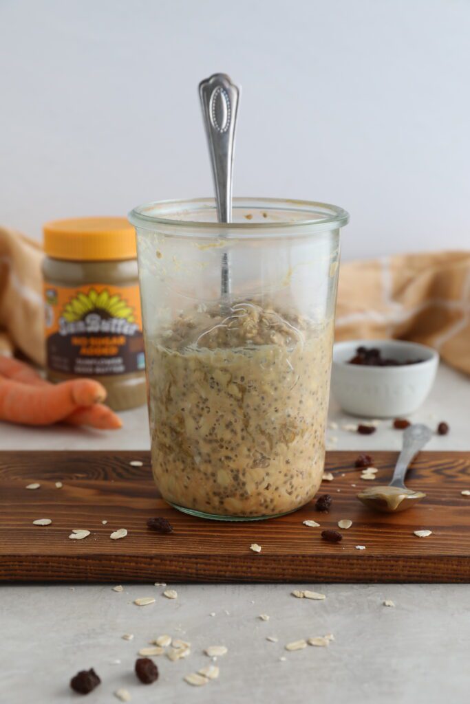 Carrot Cake SunButter Overnight Oats served in mason jars on wooden board