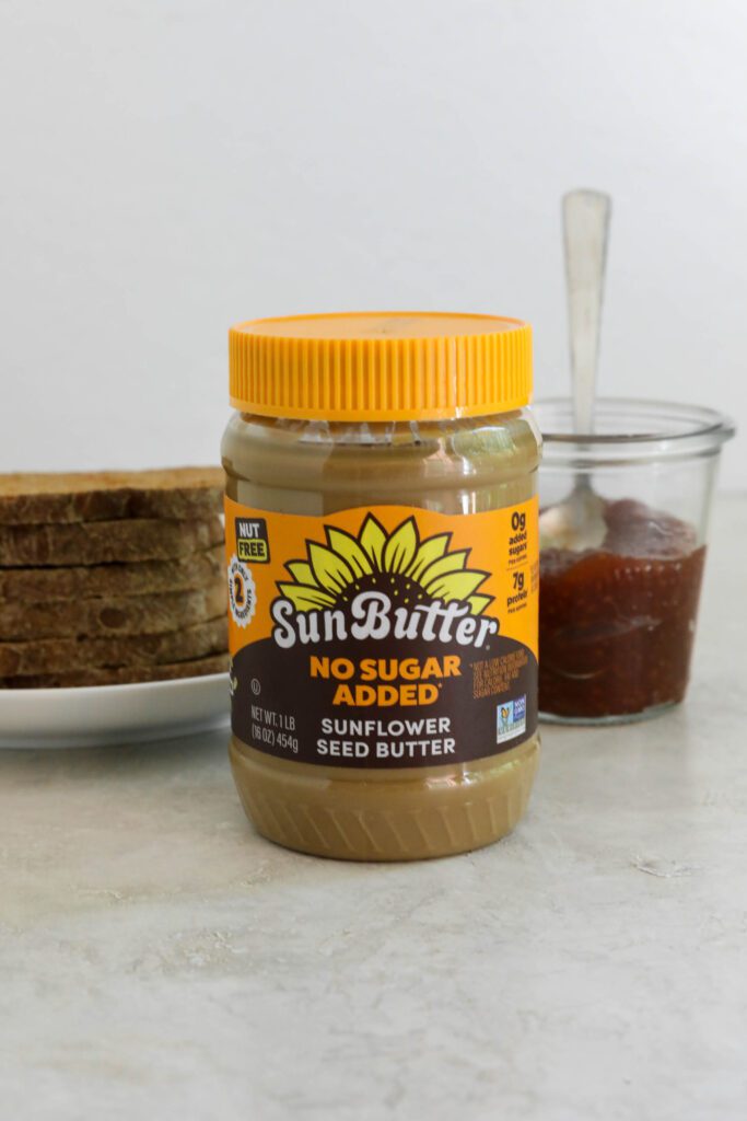 SunButter, jam, and stacked sourdough bread
