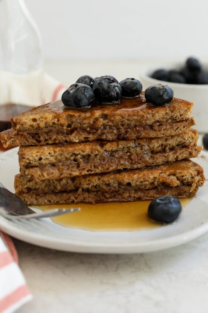 SunButter Stuffed French Toast stacked on plate topped with blueberries and maple syrup