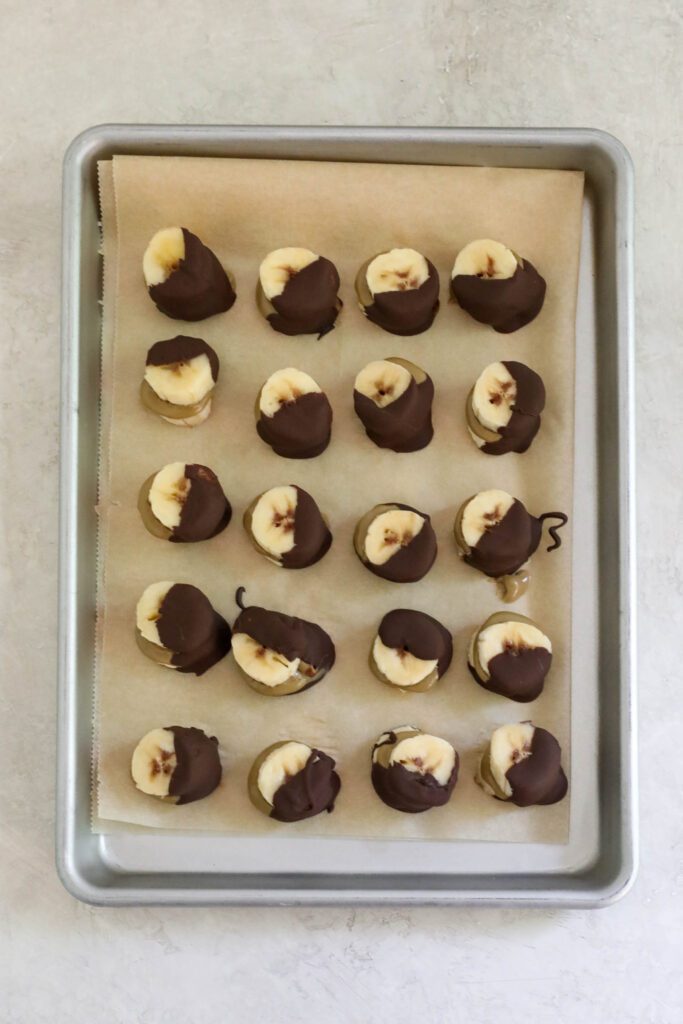 Frozen SunButter Banana Bites on parchment lined baking sheet